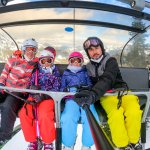 family on the chair lift while skiing