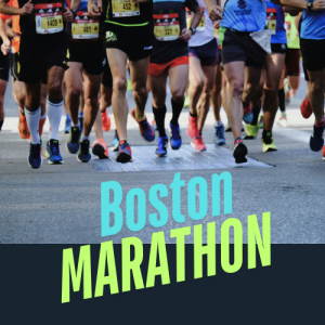Runners in the Boston Marathon making their way through city streets lined with cheering spectators and Boston banners.