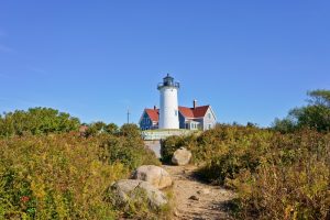 cape cod beach in the summer when tourists are visiting and staying in a vacation rental in boston to save on costs with travel discounts