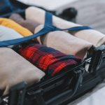 packing suitcase for traveling to boston in winter with warm clothes thanks to tips from travel experts at maverick suites